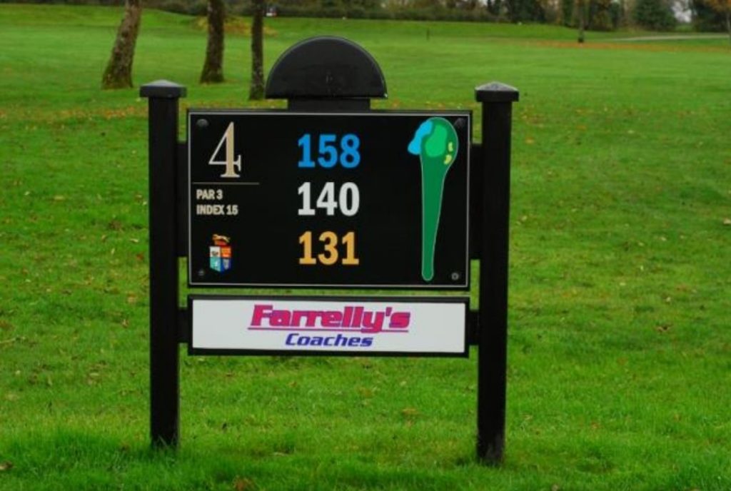 Golf course sign showing hole 4 details, including par 3 and distances: 158, 140, 131 yards, with sponsor logo.